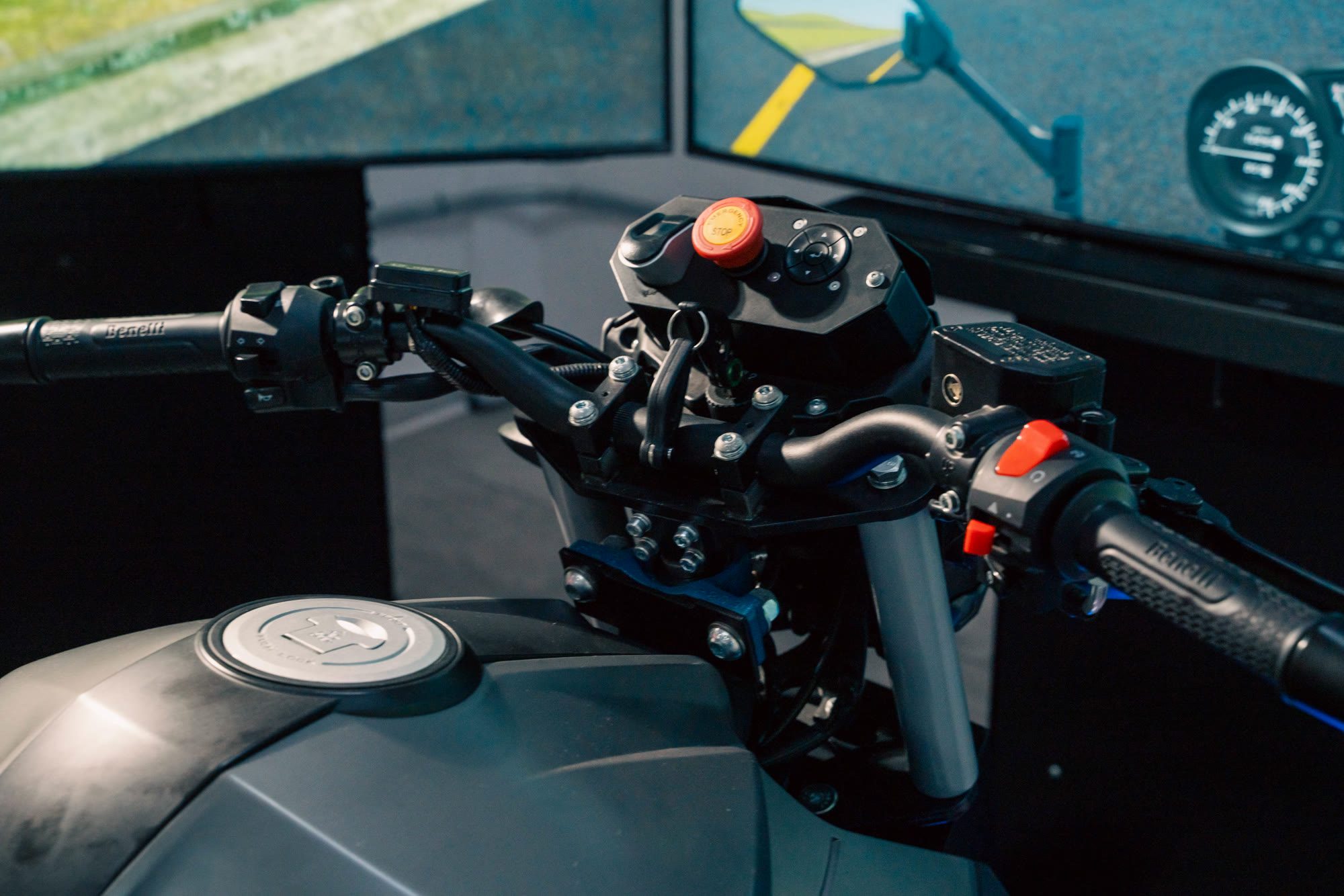 Close-up of the real handlebar controls on the APEX motorcycle simulator